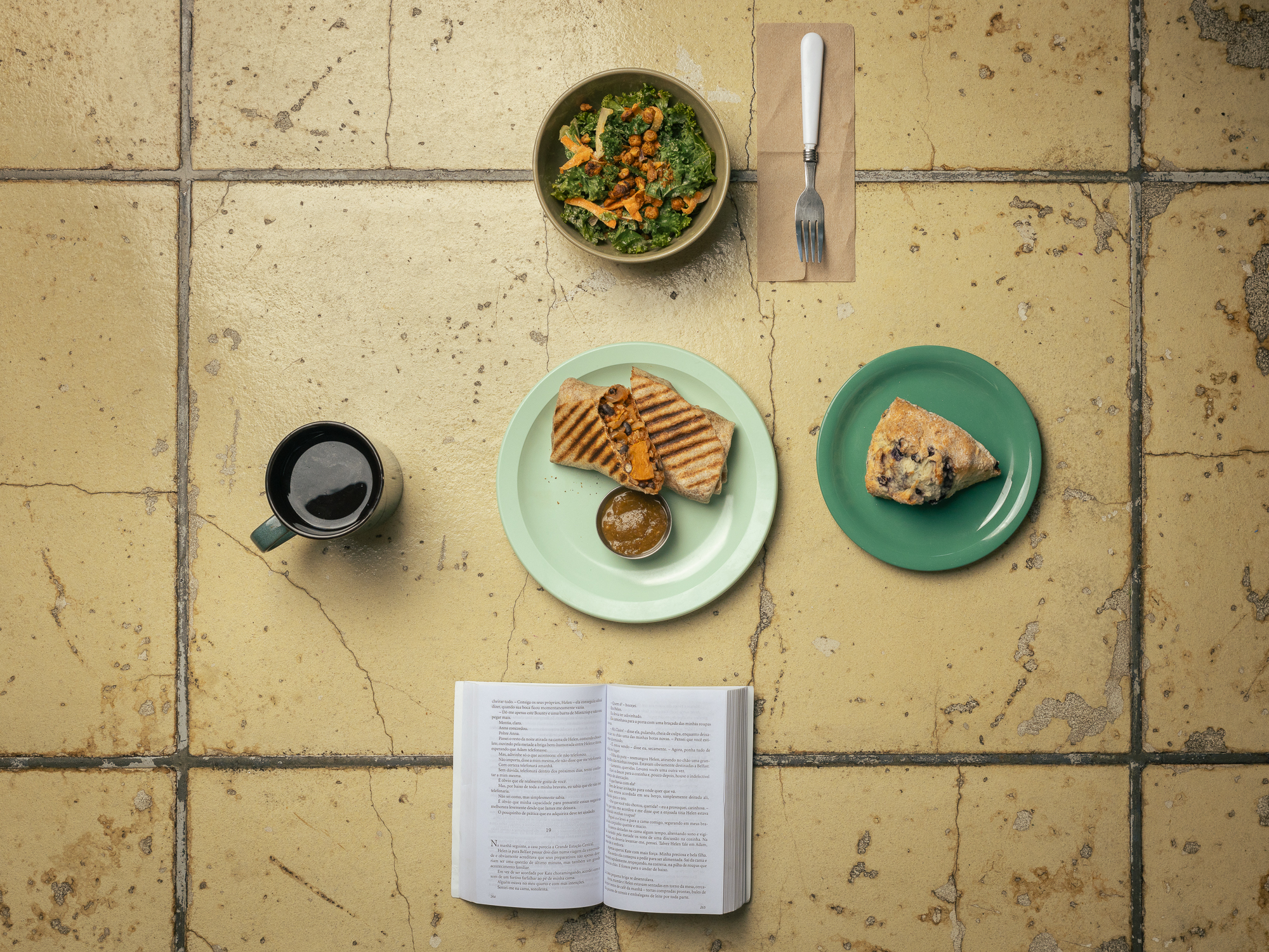 Food spread with coffee, sandwich, and salad